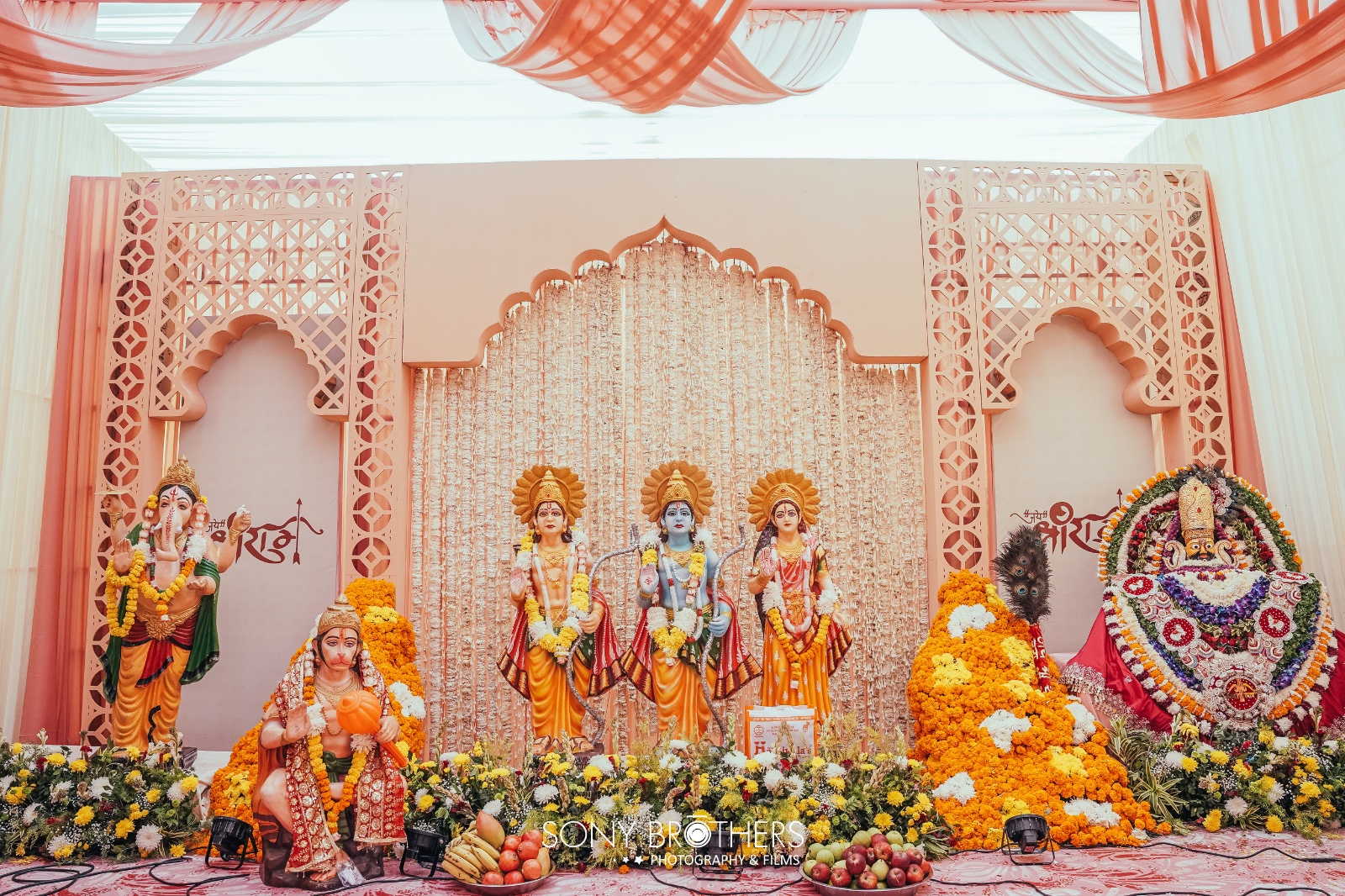 Hindu ceremony mandap with Ram Darbar and deity statues